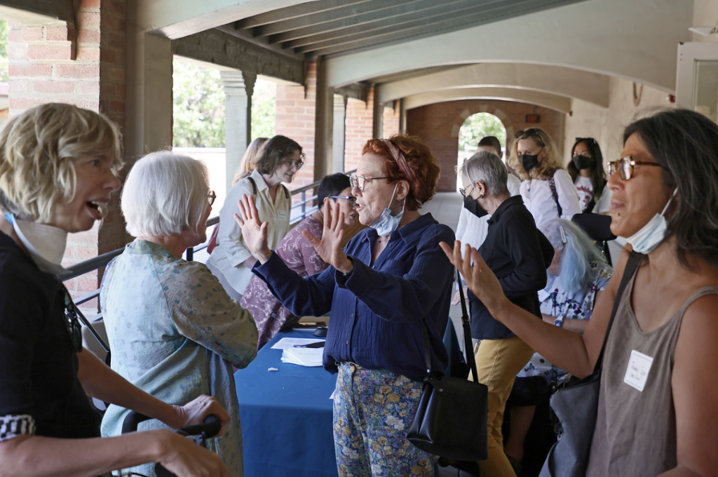 A group of individuals engage in lively conversation.